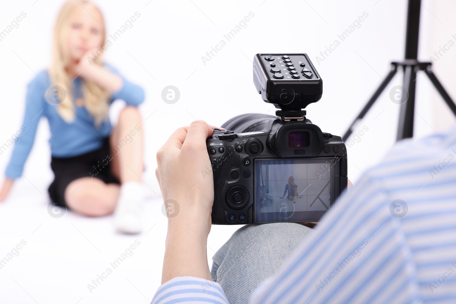 Photographer working with model in professional photo studio, selective focus Photo of Photographer working with model in professional photo studio, selective focus