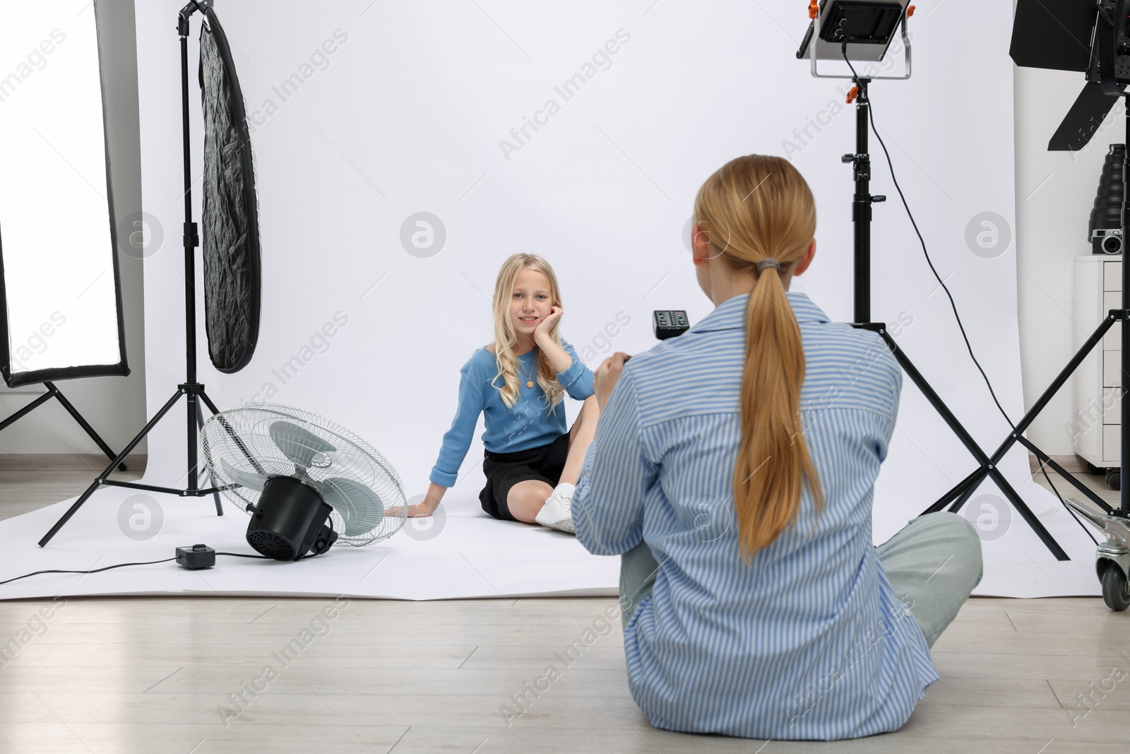 Photo of Photographer working with model in professional photo studio