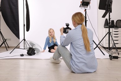Photo of Photographer working with model in professional photo studio