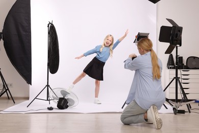 Photo of Photographer working with model in professional photo studio