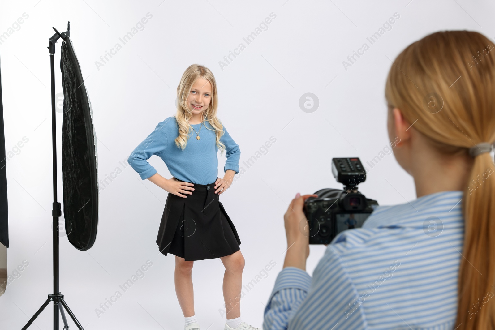 Photo of Photographer working with model in professional photo studio, closeup