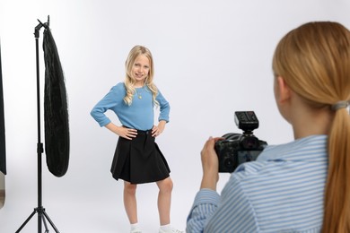 Photo of Photographer working with model in professional photo studio, closeup
