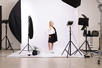 Photo of Little girl on white background in photo studio with professional equipment