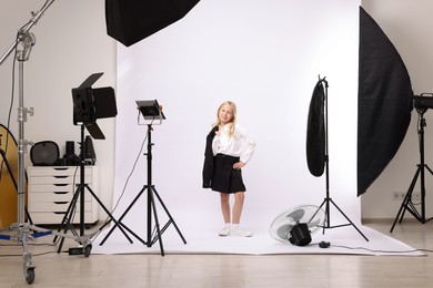 Photo of Little girl on white background in photo studio with professional equipment