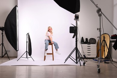 Photo of Little girl on white background in photo studio with professional equipment
