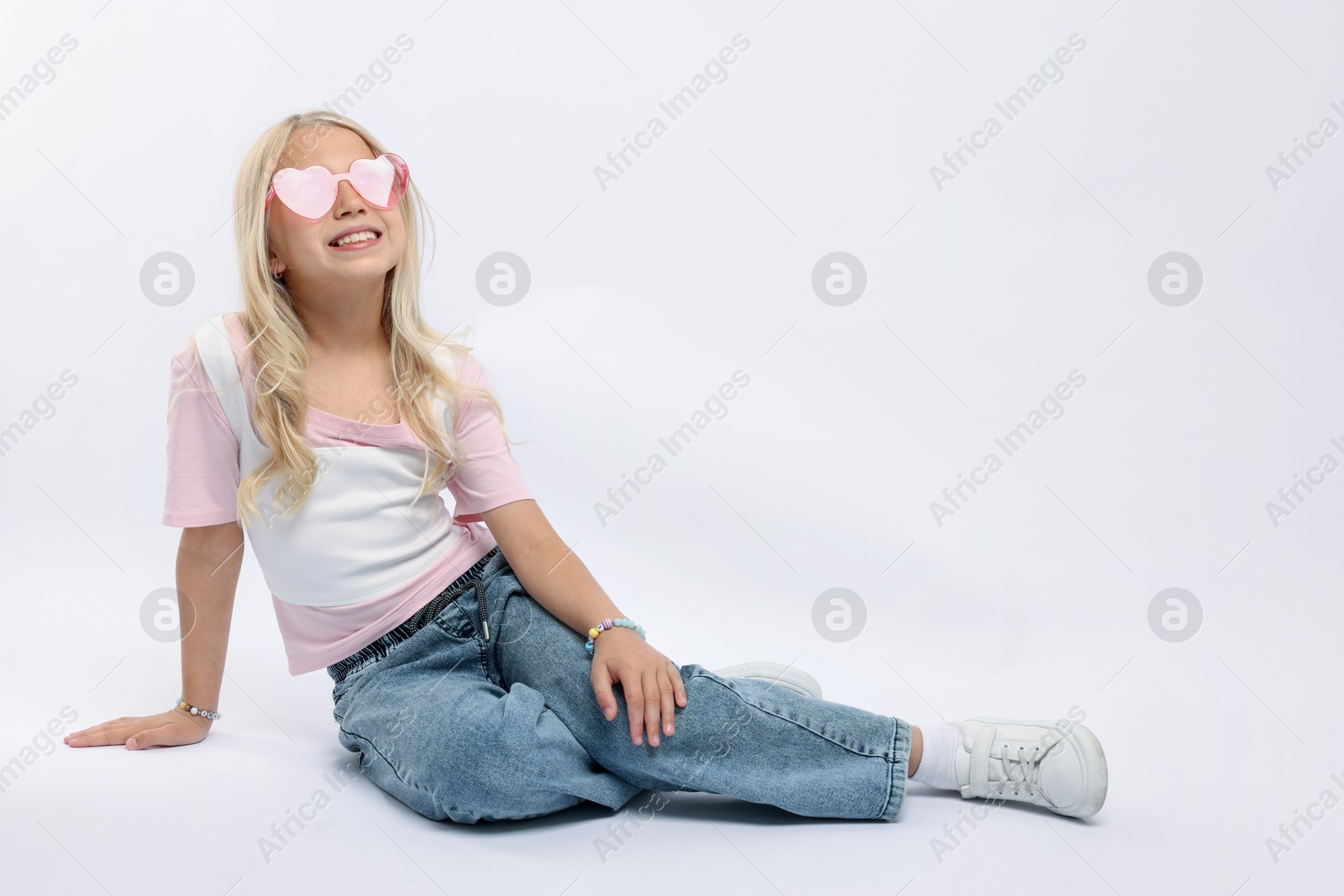 Little girl on white background in photo studio. Space for text Photo of Little girl on white background in photo studio. Space for text