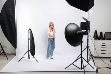 Photo of Little girl on white background in photo studio with professional equipment