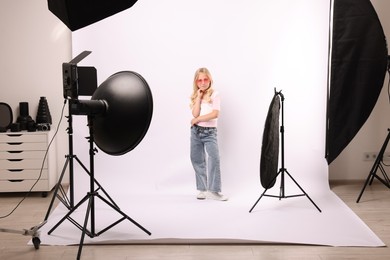 Photo of Little girl on white background in photo studio with professional equipment