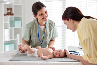 Photo of Mother and her cute baby having appointment with pediatrician in hospital