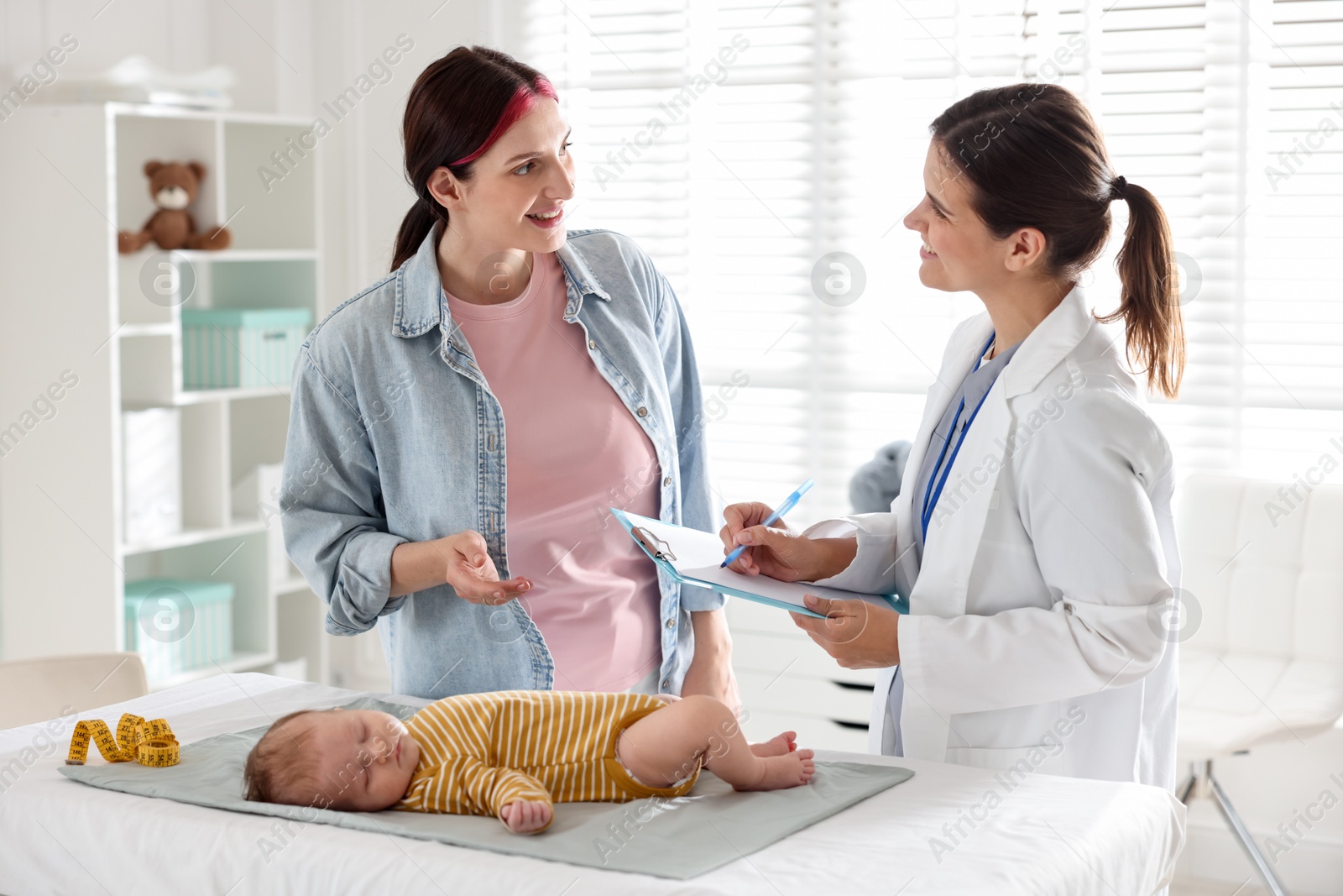 Mother and her cute baby having appointment with pediatrician in hospital Photo of Mother and her cute baby having appointment with pediatrician in hospital