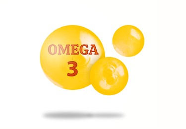 Image of Yellow drops of Omega-3 in air on white background