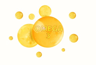 Image of Yellow drops of Omega-3 on white background