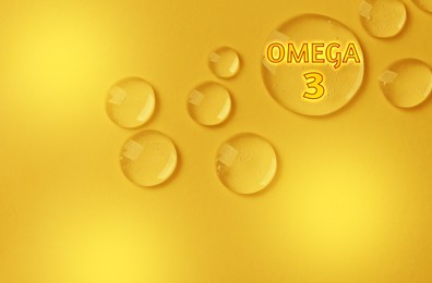 Image of Drops of Omega-3 on yellow gradient background, top view