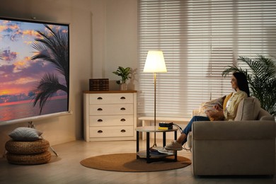 Image of Young woman watching travel show using video projector at home