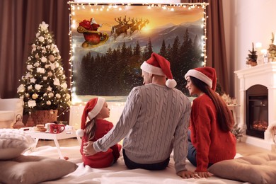 Image of Family watching Christmas movie using video projector at home