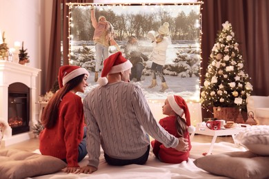 Image of Family watching Christmas movie using video projector at home