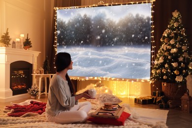 Image of Woman watching Christmas movie using video projector at home