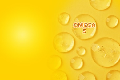 Image of Drops of Omega-3 on yellow gradient background, top view. Space for text