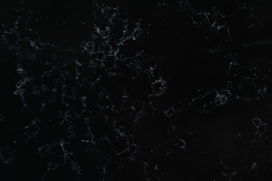Photo of Texture of black marble surface as background, top view
