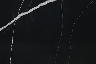 Photo of Texture of black marble surface as background, top view