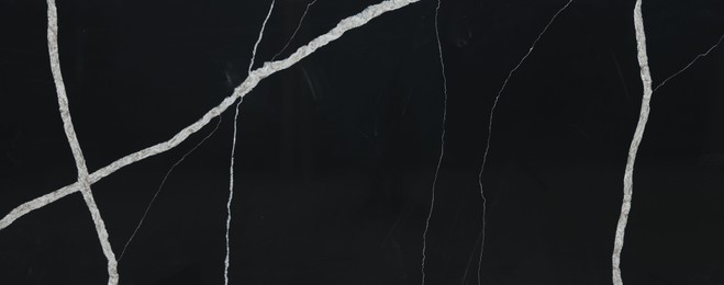 Photo of Texture of black marble surface as background, top view