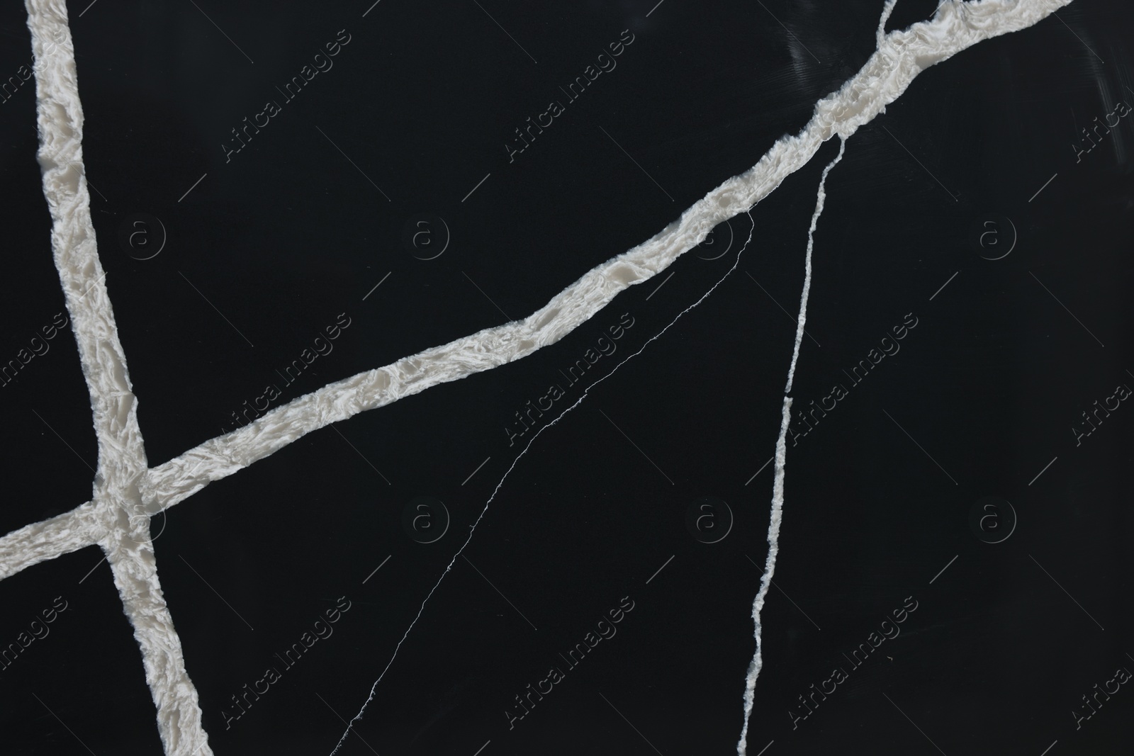 Photo of Texture of black marble surface as background, closeup