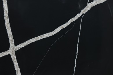 Photo of Texture of black marble surface as background, closeup