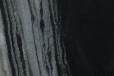 Photo of Texture of black marble surface as background, closeup