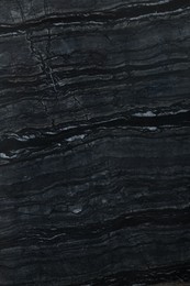 Photo of Texture of dark marble surface as background, top view