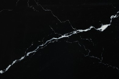 Photo of Texture of black marble surface as background, top view