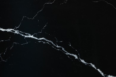 Photo of Texture of black marble surface as background, top view