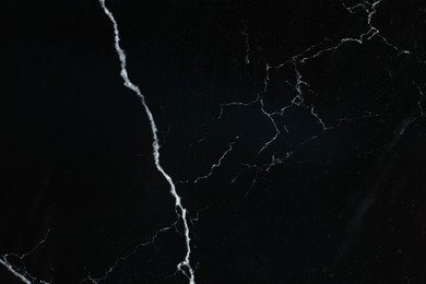 Photo of Texture of black marble surface as background, top view
