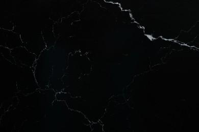 Photo of Texture of black marble surface as background, top view