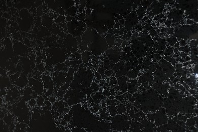 Photo of Texture of black marble surface as background, top view