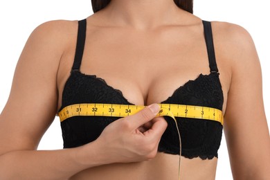 Photo of Woman in beautiful bra measuring breast circumference on white background, closeup