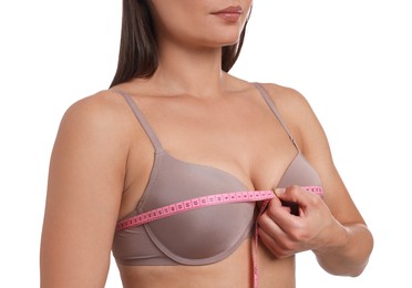 Photo of Woman in beautiful bra measuring breast circumference on white background, closeup
