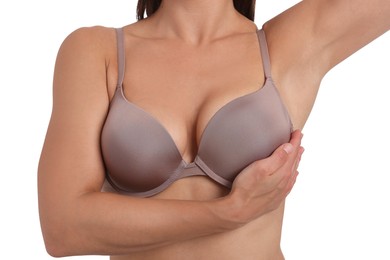 Photo of Woman wearing beautiful beige bra on white background, closeup