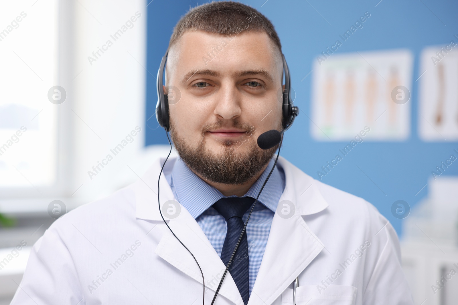 Doctor with headset in clinic. Online medical consultation Photo of Doctor with headset in clinic. Online medical consultation