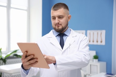 Photo of Doctor with tablet in clinic. Online medical consultation