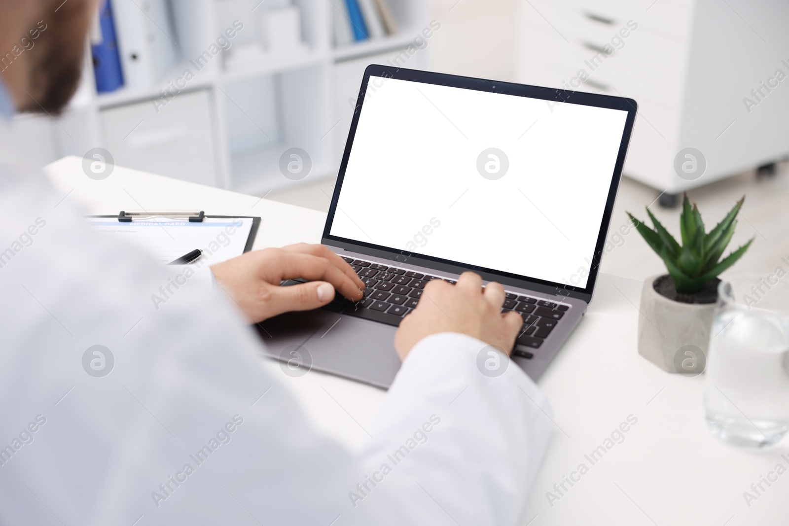 Doctor having online consultation via laptop in clinic, closeup Photo of Doctor having online consultation via laptop in clinic, closeup