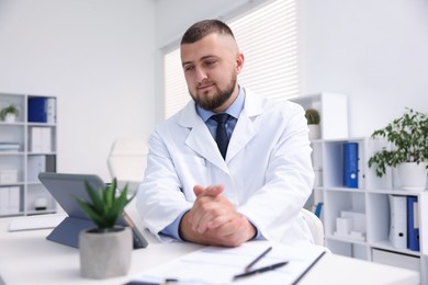 Photo of Doctor having online consultation via tablet indoors