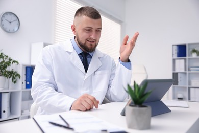 Photo of Doctor having online consultation via tablet indoors