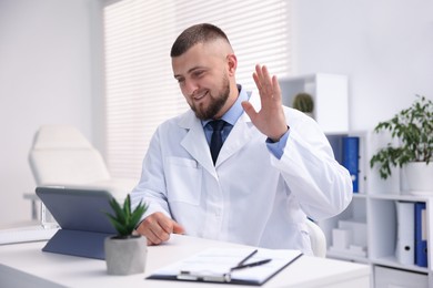 Photo of Doctor having online consultation via tablet indoors