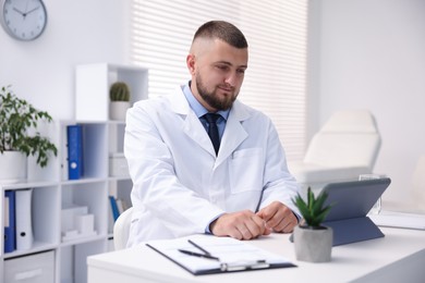 Photo of Doctor having online consultation via tablet indoors