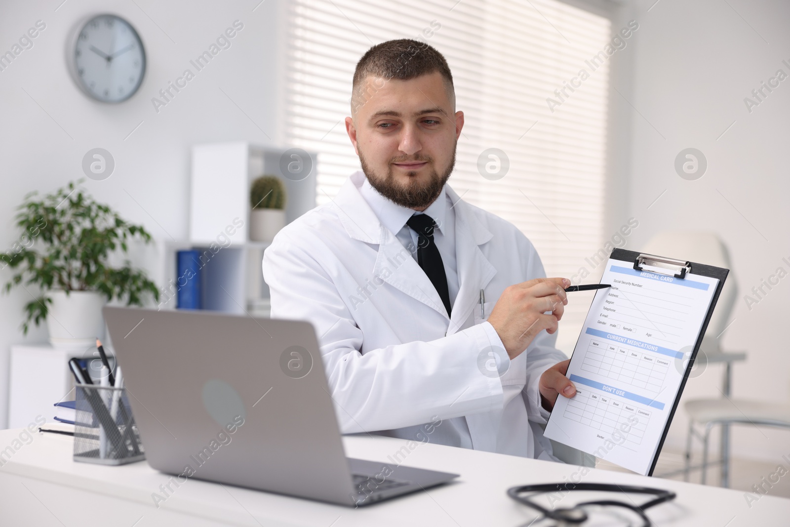 Doctor having online consultation via laptop in clinic Photo of Doctor having online consultation via laptop in clinic
