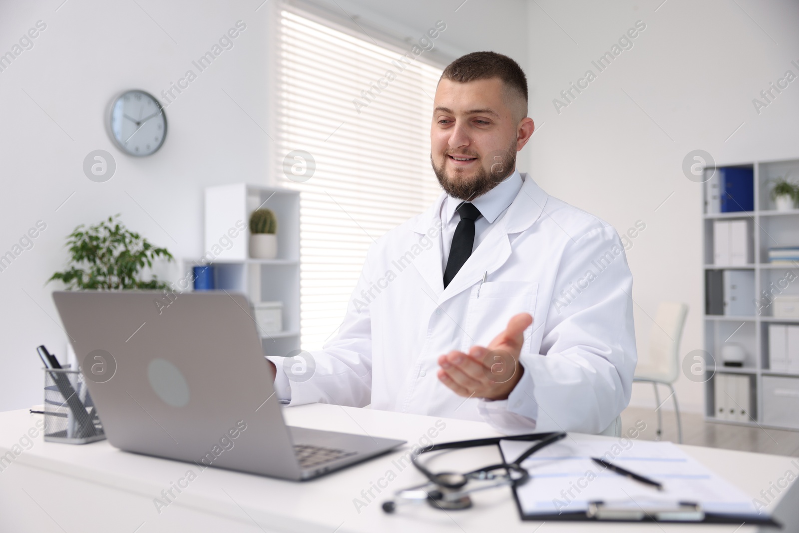 Photo of Doctor having online consultation via laptop in clinic