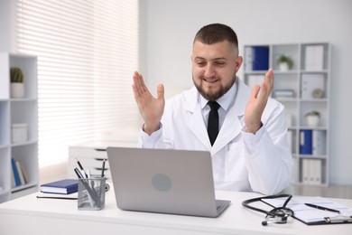 Photo of Doctor having online consultation via laptop in clinic