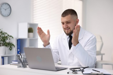 Photo of Doctor having online consultation via laptop in clinic
