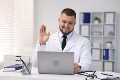 Photo of Doctor having online consultation via laptop in clinic