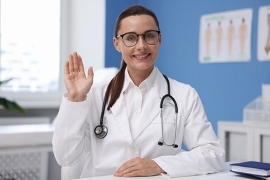Photo of Portrait of happy doctor in glasses indoors